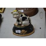 A cast iron doorstop in the form of a cow