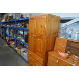 A pine wardrobe fitted three drawers below AF