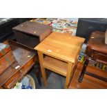 A pine two tiered table together with a wood effec