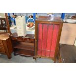 A glazed display cabinet raised on claw and balls