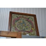 A needlework embroidery contained in oak frame