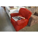 A large red upholstered reclining armchair