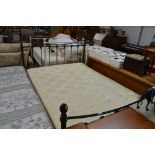 A metal double bed frame and mattress