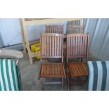 A set of four teak folding garden chairs