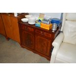 A reproduction mahogany cabinet fitted two drawers