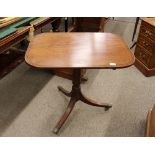 A Georgian mahogany occasional table, the rectangular snap top raised on turned column and triple