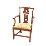 An Antique elm elbow chair, in the Chippendale manner, having pierced splat back and needlepoint