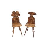 An unusual pair of fruitwood figural hall chairs, in the form of a man and woman, solid shaped seats