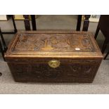 An Oriental relief carved camphorwood trunk, 89cm  wide