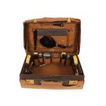 A Finnigan's leather cased travelling toilet set, and contents of faux tortoiseshell and silver