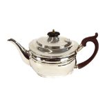 An Edwardian silver teapot, of oval form with reeded band decoration, wooden handle and lift, London