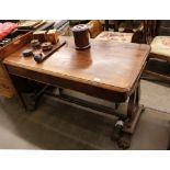 A Victorian rosewood library table, fitted two blind frieze drawers, raised on lyre shaped end