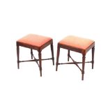 A pair of 19th Century mahogany dressing stools, raised on turned supports