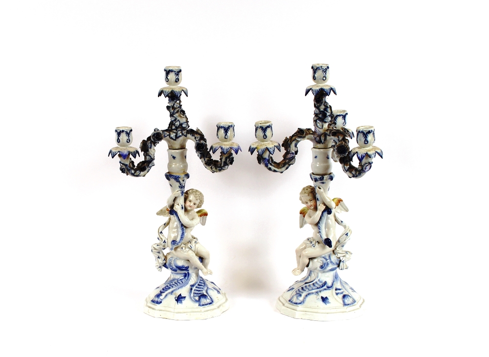 A pair of 19th Century Dresden cherub decorated candelabra, 44cm high, AF