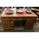 A 19th Century mahogany pedestal partner's desk, the red and gilt leather inset top fitted six