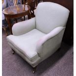 Howard & Sons, a walnut framed deep seated easy chair, raised on ring turned tapering front supports