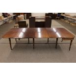 A Victorian mahogany extending dining table, having foldover end section and extra leaves, raised on