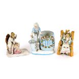 A Continental porcelain posy holder, in the form of a boy with barrel and grape hod; and two