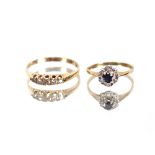 A sapphire and diamond cluster ring; and a five stone diamond set ring, (2)