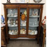 An Edwardian inlaid mahogany display cabinet, the fabric lined shelves enclosed by bowed glazed