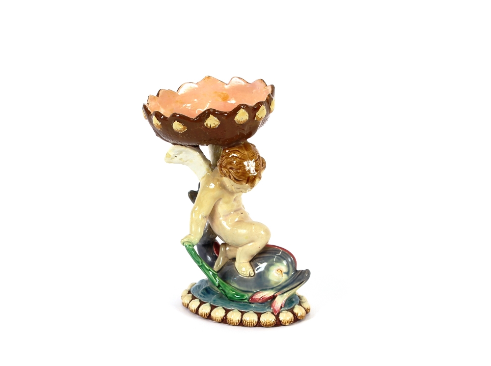 A Minton majolica posy holder, in the form of a cherub seated on a dolphin, 17.5cm high, AF