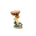 A Minton majolica posy holder, in the form of a cherub seated on a dolphin, 17.5cm high, AF