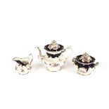A Coalport type tea set, having floral spray decoration on a rich blue ground, heightened in gilt,