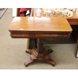 A Victorian mahogany card table, the rectangular foldover swivel top raised on octagonal column