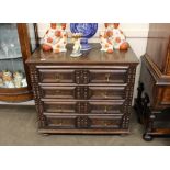 An oak Jacobean style chest, fitted three long moulded panelled drawers with brass acorn drop