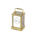 A brass cased carriage timepiece, having white enamel Roman numeral dial, angular swing handle, 16cm