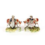 A pair of Staffordshire cow groups, depicting farmer and milkmaid