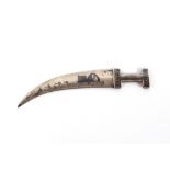 An Iraqi white metal and Niello work paper-knife, in the form of a dagger with camels and