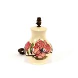 A Moorcroft pottery table lamp, Magnolia pattern, complete with shade