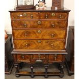 An 18th Century walnut chest on stand, the upper section fitted two short and three long graduated