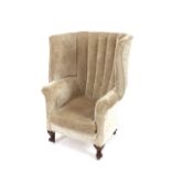 A late 19th/early 20th Century mahogany framed porter's type barrel back chair, upholstered in beige