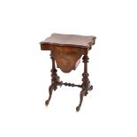 A Victorian walnut sewing table, the shaped quarter veneered top lifting to reveal a partitioned