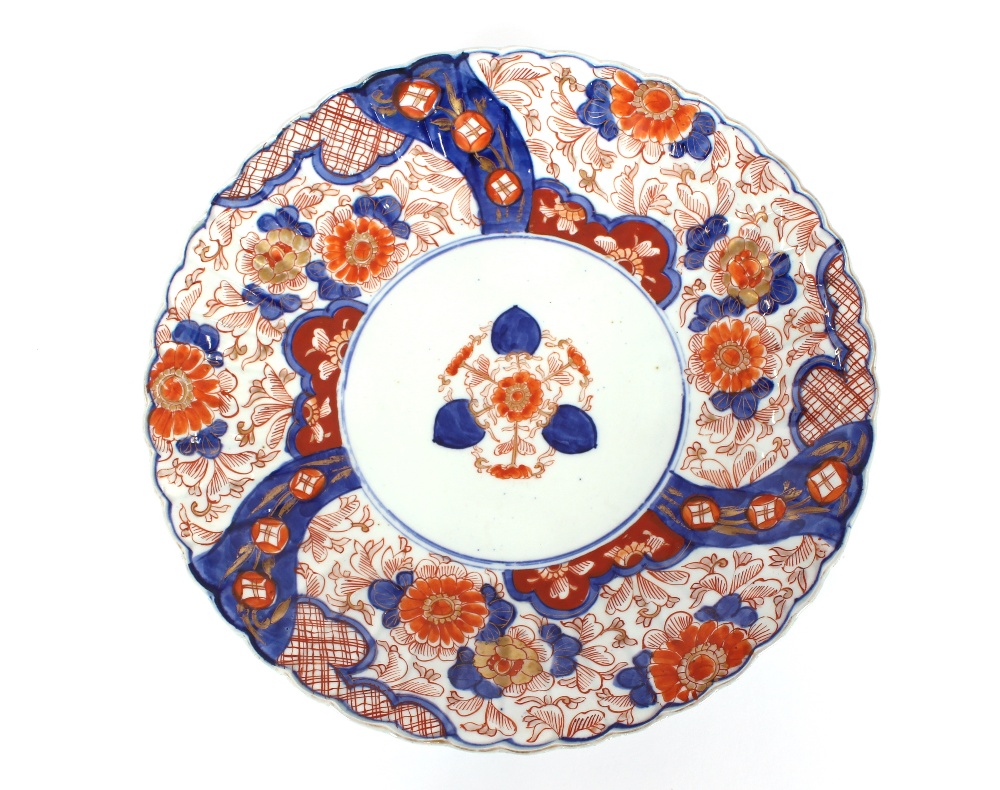 A pair of Imari chargers, having scallop borders and decorated in the traditional manner
