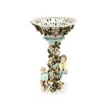 A 19th Century German porcelain table centre piece, decorated with children climbing a floral