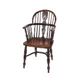 A 19th Century yew wood Windsor chair, having elm seat raised on turned supports united by a