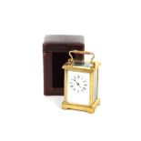 A brass cased French carriage clock, with enamel Roman numeral dial, contained in leather travelling