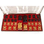 A cased carved Indian sandalwood chess set