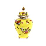 A 19th Century Dresden baluster vase and cover, decorated with foliate sprays on a yellow ground,