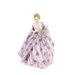 A Continental porcelain figure of a young maiden, in mauve rose decorated flowing dress, 24cm high