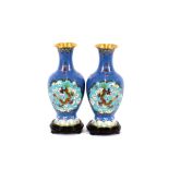 A pair of Chinese cloisonne vases, decorated with dragons and flaming pearls, seal mark to bases,