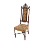 A Victorian rosewood nursing chair, having needlepoint upholstered seat and back panel, flanked by