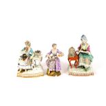 A Meissen porcelain figure group, depicting a lady seated by a table with basket of flowers; another