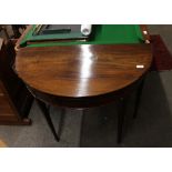 A 19th Century mahogany demi lune and inlaid foldover card table, raised on square tapering