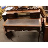 An Edwardian mahogany writing desk, having raised back, fitted mirrored panel and two short drawers,