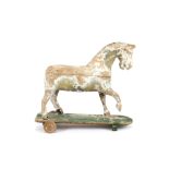 An Antique wooden pull-a-long horse, (in need of restoration)