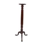 A 19th Century mahogany torchere, raised on fluted column and tripod base